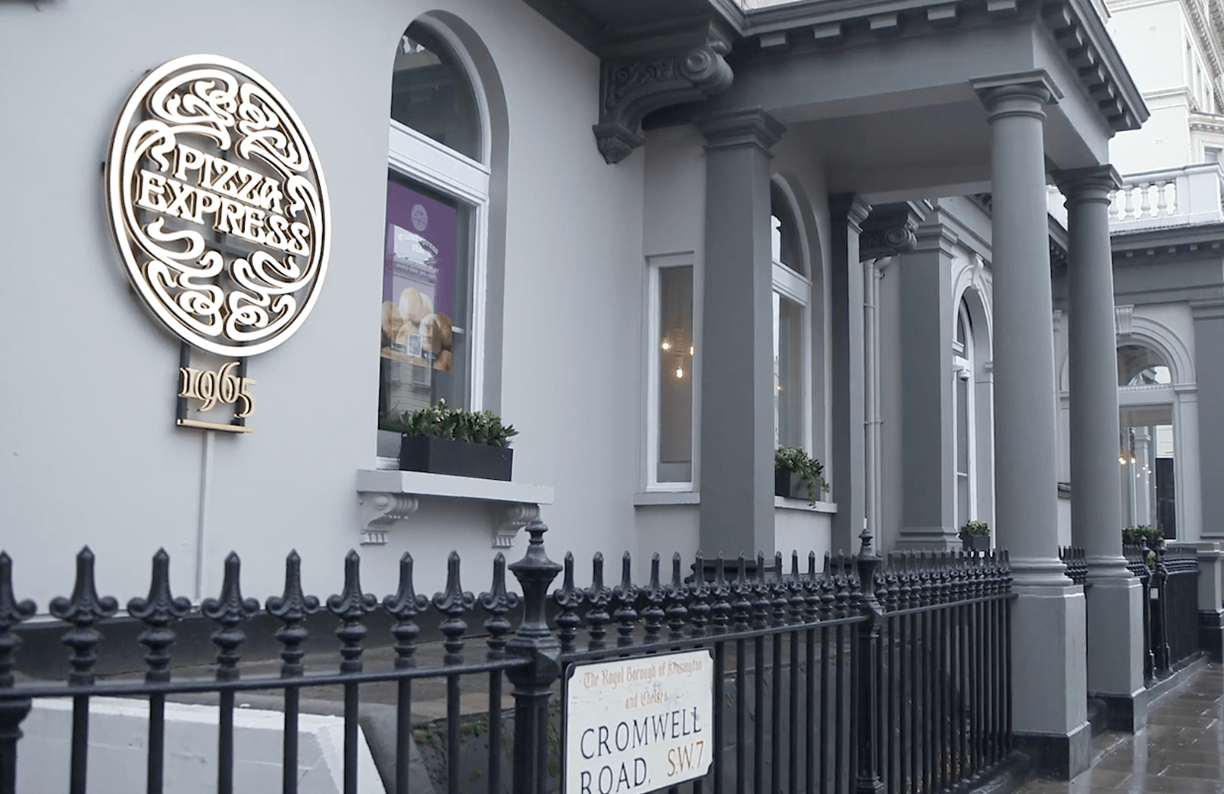 Exterior of a building showcasing a sign on the facade.