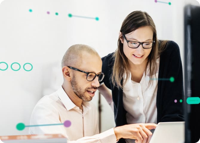 Two coworkers working together surrounded by abstract data points