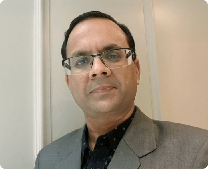 Portrait of Sunil Jagnani, Senior Principal Advisor, standing against a light background. 