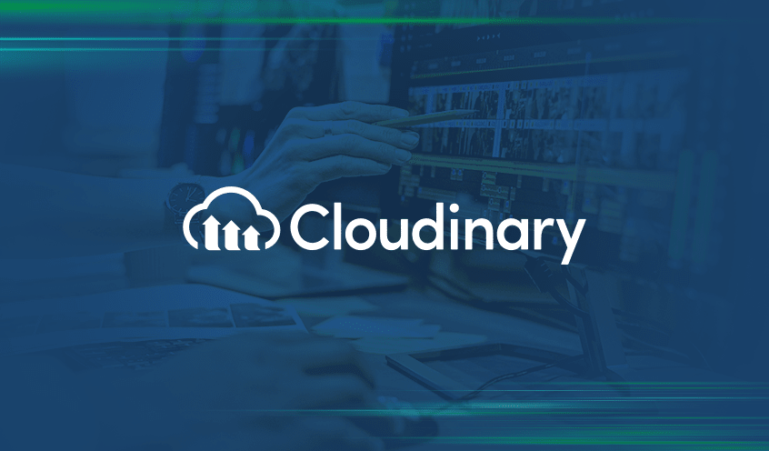 The image shows the logo of Cloudinary, overlaid on a blurred background of two individuals collaborate on a computer screen displaying various graphics and analytical data.